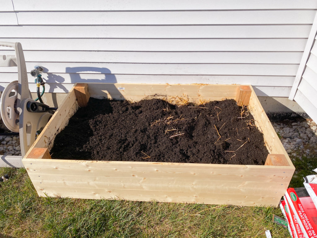 layering garden bed with compost